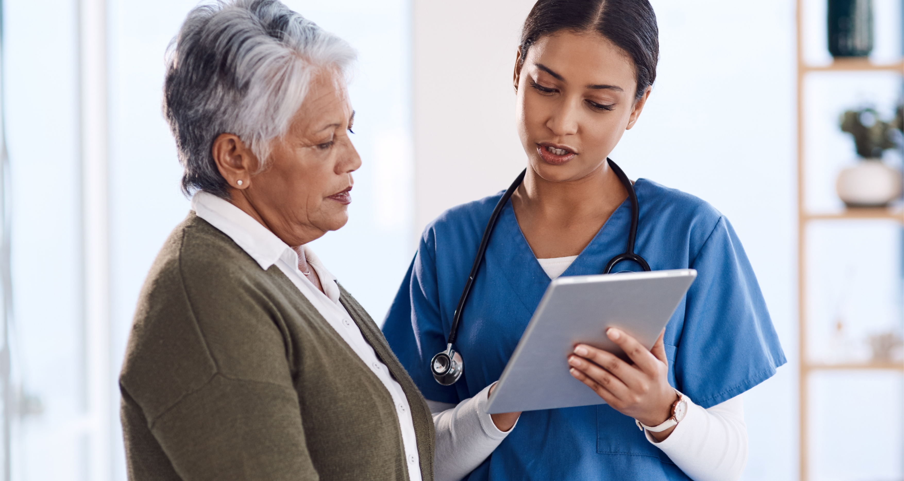 health worker speaking to patient using iPad