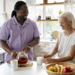 Carer smiling with elderly lady.