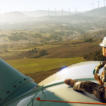 Lone worker sitting on wind turbine