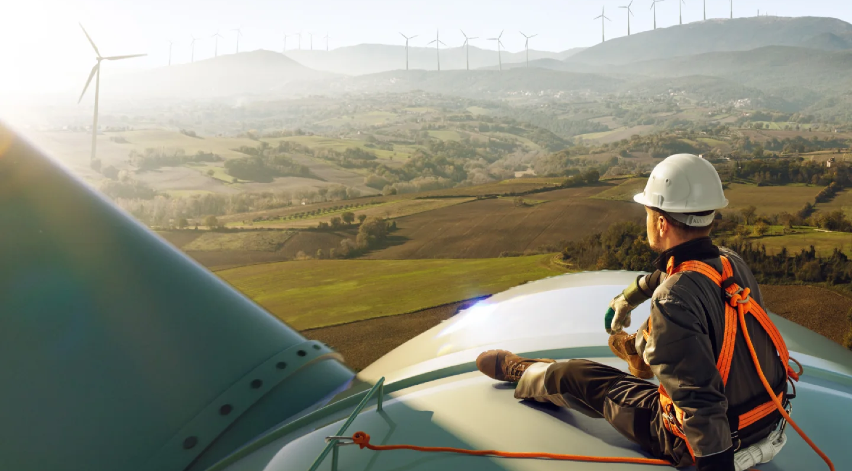 Lone worker sitting on wind turbine