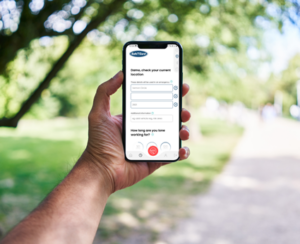 Man holding phone showing the SafeTCard Personal Safety Mobile App